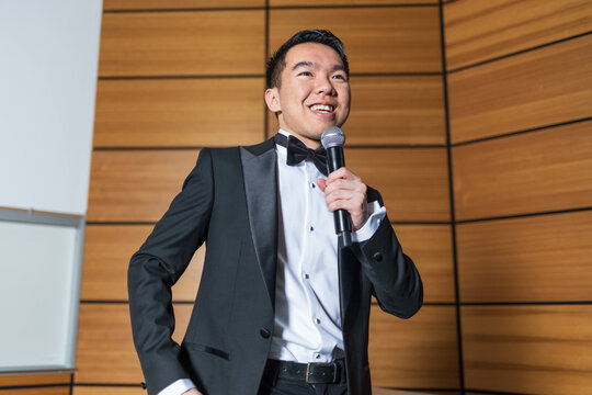 Young man giving a speech as the emcee of an event