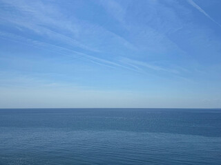 Ocean calm blue water and sky horizon.