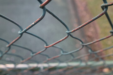 Rusty chain linked fence metal rust and came off paint 
