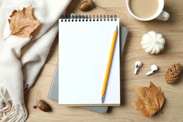 Workplace with notebook, pencil, autumn leaves and cup of coffee, top view 