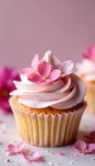 A delicate cupcake with pale pink cream frosting and edible flowers on top, dessert photography, floral arrangements
