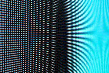 Close-up photo of video wall screen displaying blue color with grid layout of pixels for digital panel LED display with mesh diodes.