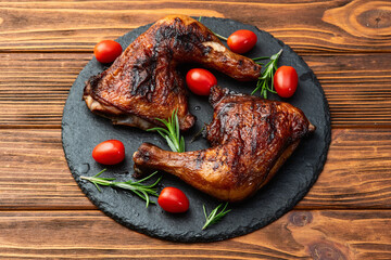 Grilled chicken legs with tomatoes and salad . Top view