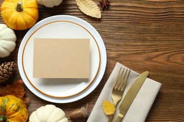 Rustic holiday table setup. Top view with plates, cutlery and autumn decorations. Empty space for your text 