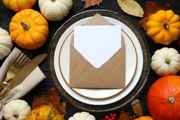 Rustic holiday table setup. Top view with plates, cutlery and autumn decorations. Empty space for your text 