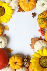 Beautiful autumn composition with pumpkins and leaves on a white background, top view