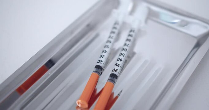 Amazing slow motion shot of Botox injection syringes in a dermatological clinic