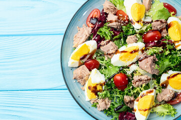 Canned Tuna salad with eggs and tomatoes photography . Top view