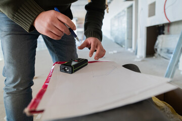 A close-up of an engineer's hand meticulously sketching an architectural project, capturing the precision, creativity, and focus involved in bringing innovative designs to life