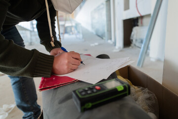 A close-up of an engineer's hand meticulously sketching an architectural project, capturing the precision, creativity, and focus involved in bringing innovative designs to life