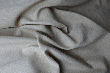 Abstract textured background with cream grungy textile folds, perfect for design applications