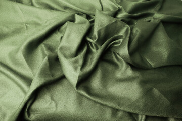Abstract textured background with light green grungy textile folds, perfect for design applications