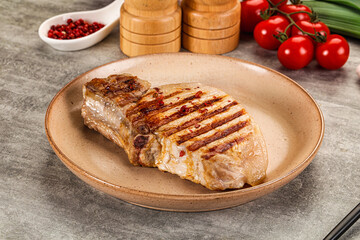 Grilled pork loin steak with bone