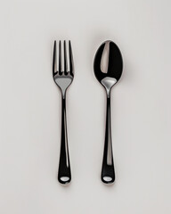 Black Fork and Spoon: A simple yet elegant arrangement of a fork and spoon in black, capturing the essence of minimalist design and culinary sophistication.  