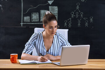 Photo of beautiful young woman at workplace