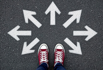Sneakers shoes and arrows pointing in different directions on asphalt floor, life and studies choice for young people concept