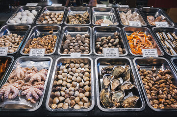 Seafood, including shrimp, octopuses, clams, sea snails, squid, octopus and mussels, are sold at the kiosk of the Asian fish market.