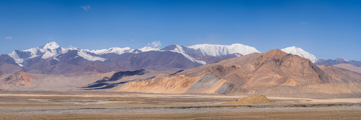 Colorful landscape panorama with snowcapped mountains on high altitude Pamir Highway between Karakul and Kyzyl Art, Gorno-Badakhshan, Tajikistan