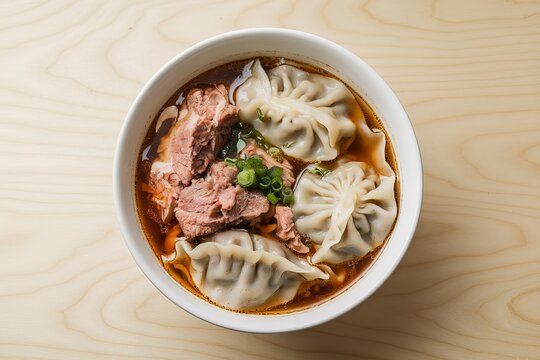 a bowl of dumpling soup with meat