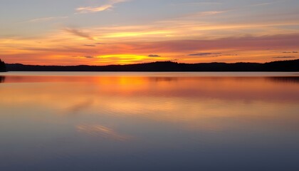 Obraz premium Serene Sunset over a Calm Lake