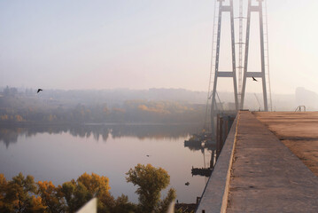 Unfinished bridges in Zaporozhye, dawn fog, view of the city. Ukraine