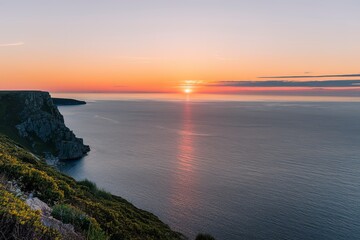 Fototapeta premium A breathtaking sunset over a vast expanse of calm sea