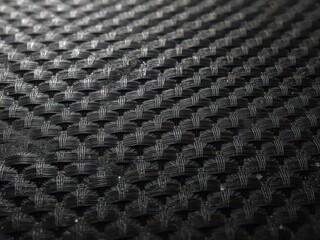 Intricate woven carbon fiber showing texture and depth, textured,strength