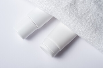 White plastic tube for cosmetic with terry towel, minimalistic concept