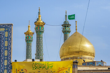 Panorama of the domes and minarets of the Fatima Masumeh shrine in Qom, Iran. Also visible are religious banners with quotations from the Koran