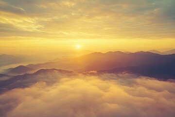 Obraz premium Plane is flying over mountain peaks in low clouds at golden sunrise. Top view of passenger airplane, colorful sky, hills in fog. Aircraft is taking off. Business travel. Commercial. Aerial view