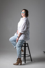 Fototapeta premium Portrait of a young beautiful plump girl in the studio.