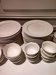 various types of white dinner plates and bowls