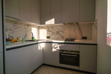 Kitchen Design Modern Apartment Sunlight Italy: Contemporary gray kitchen showcasing marble backsplash, built-in appliances, natural light.