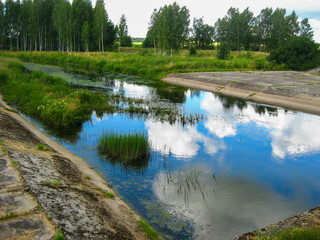 A calm river in the woods, a water channel