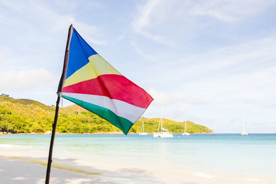 The flag of Seychelles is mounted on the beach