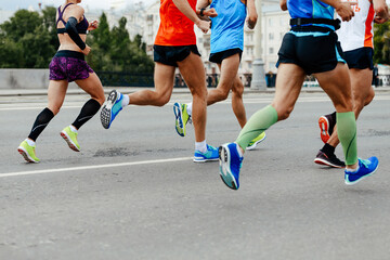 Fototapeta premium group men and woman running marathon together in city