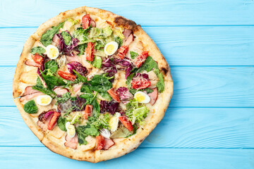 Italian pizza caesar with eggs salad chicken tomatoes and mozzarella photography. top view