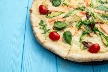 Italian pizza with avocado salmon  tomatoes and mozzarella photography. top view