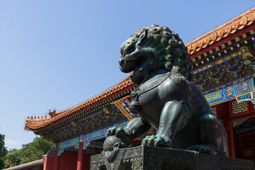 Fototapeta premium The cloud gate and bronze lion statue at the Summer Palace in Beijing, China