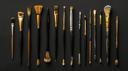 A collection of paint brushes on a black background.