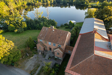 Naklejka premium An old brick factory building in original vintage architectural style. Old Scandinavian architecture, aerial view, drone shot.