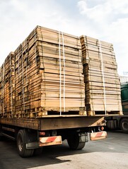 heavy load delivery truck carrying stacked wooden pallets in sunny industrial area : Generative AI
