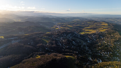 Fototapeta premium Aerial View of Austrian Villages and Wild Forests: Drone Footage of Austria's Untouched Nature, showcasing the breathtaking beauty of remote landscapes.