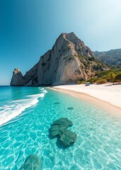 Fototapeta premium Beach Wallpaper of A secluded beach with clear blue water white sand and a large cliff in the background beach wallpaper summer wallpaper beach background tropical nature