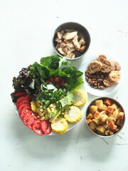 a set of healthy meal with chicken, potato, bread and fresh vegetable salad