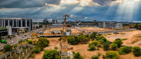 Gaborone, Botswana, aerial view, capital city, panorama of the central business district and shopping mall, crane in the foreground © poco_bw