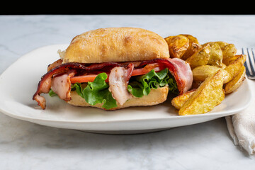 ciabatta blt sandwiches served with  a  side potato wedges,