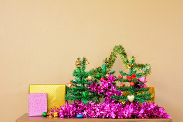 Small Christmas Tree with Decorative line and Gift Boxes on Table