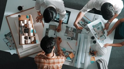 Time lapse of engineer team working while working on laptop with sticky notes and calculator to design building construction. Manager working and using calculator to calculate blueprint. Alimentation.