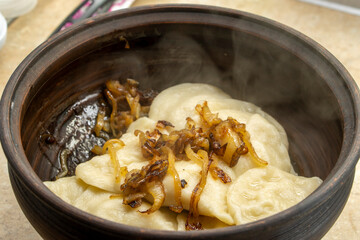 Ukrainian cuisine. vareniki with potatoes and fried pork fat and onions - cracklings. food concept